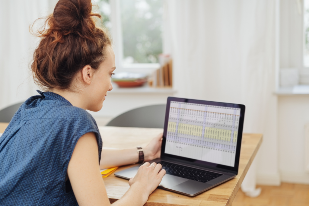 Image of a woman who is an NC Trust Administrator reviewing a spreadsheet as part of her fiduciary duties.