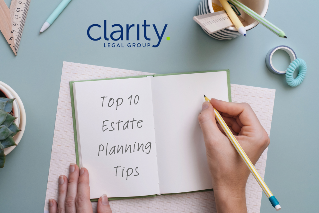 Person writing in a notebook that has the words Top 10 Estate Planning Tips