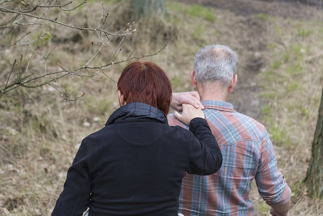 Two people walk, with one providing support to the other. This illustrates the special role of caregivers.