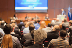 Photo of people in the audience at a conference to represent our attorneys attending the AAEPA Spring Summit and the benefits that brings you.