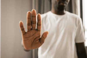 Photo of a man putting his hand out in a motion to signal "stop." This is to represent someone declining the executor role in NC.