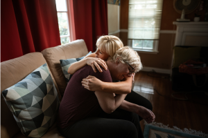 Image of people hugging in grief to illustrate the need to avoid estate administration mistakes.