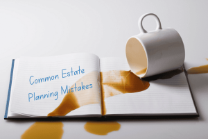 Image of coffee spilled over a notebook that has the words "Common Estate Planning Mistakes" written on it.