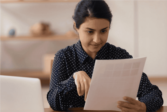 Photograph of a woman reviewing her north carolina living will and healthcare documents.
