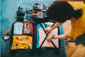 An image of a person packing a bag for vacation. This illustrates the idea of estate planning for incapacity while traveling.