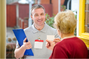 Photo of a repair man at the front door to illustrate the idea of "Summer Scams: Protecting Seniors from Financial Abuse"
