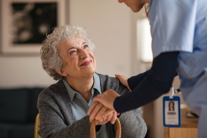 Image of an older woman smiling at a caregiver. Illustrates the topic of a Special Needs Trust for Alzheimer's.