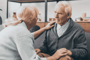 Woman with her hand on the shoulder of a man who looks confused. This illustrates the need for estate planning for cognitive decline
