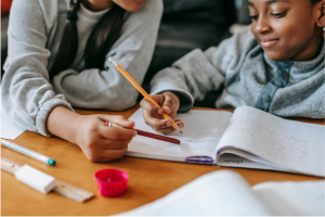 A mother and her daughter "reviewing" homework as a playful representation of the need to Review Your Estate Plan