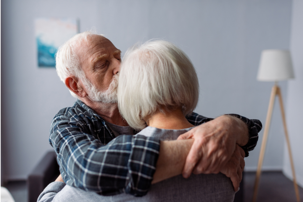 An image of a husband embracing his wife to comfort her. This illustrates the need for Alzheimer’s estate planning in North Carolina