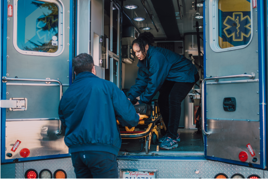 Image of paramedics loading a person into an ambulance to illustrate the need for crisis preparedness for caregivers