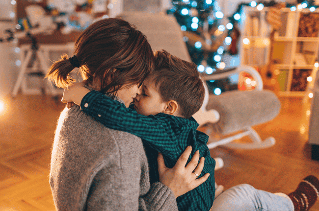 Photo of a woman and a child with a Christmas tree background to illustrate the concept of guardianship provisions during the holiday.
