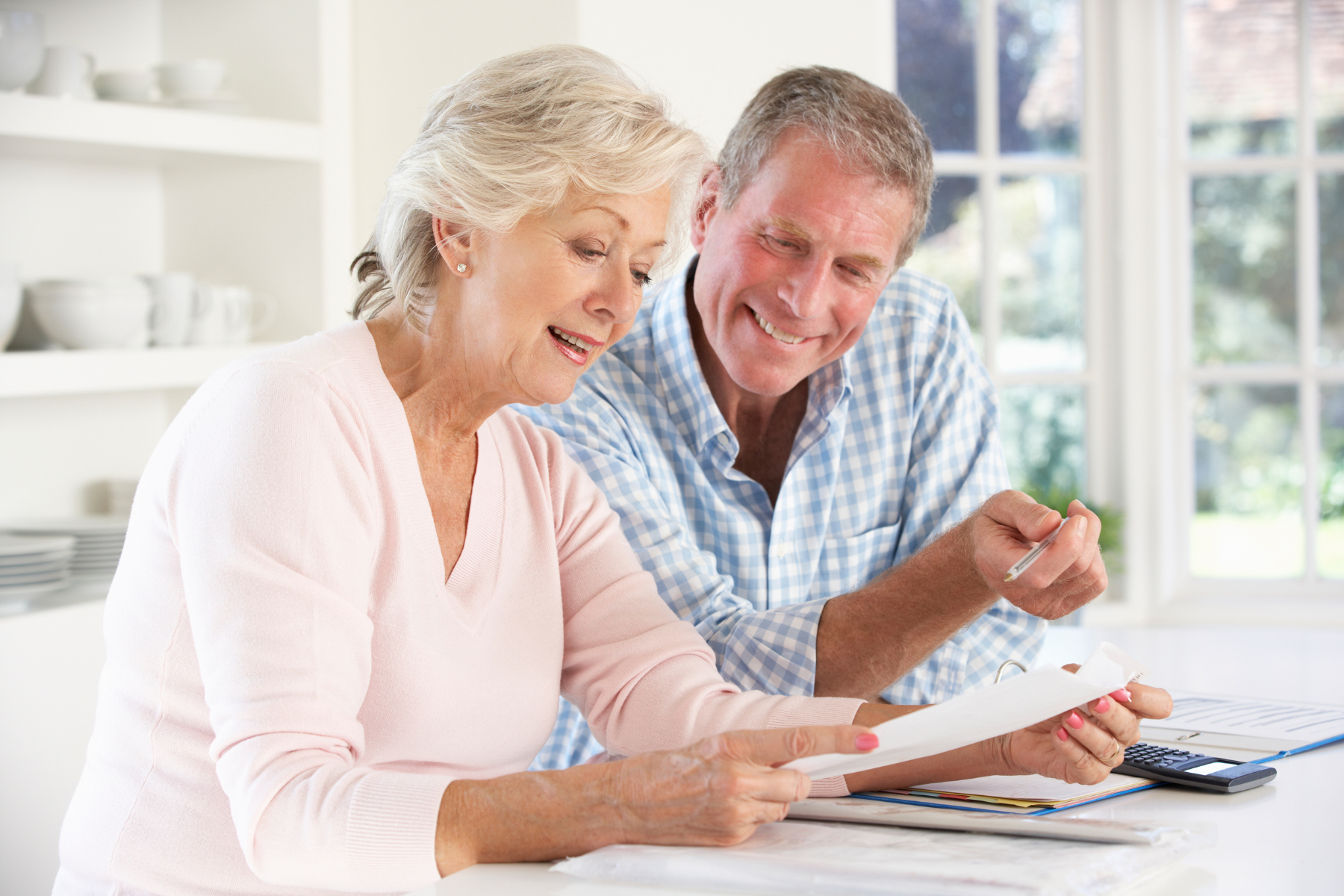 Image of a couple reviewing their documents as part of an estate planning checkup.